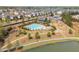 Beautiful aerial view of a neighborhood pool, clubhouse, lake, and walking paths at 4425 Atwood Dr, Cumming, GA 30040
