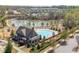 A stunning view of the community pool area with a large pool, clubhouse, and lake at 4425 Atwood Dr, Cumming, GA 30040