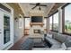 Relaxing screened porch with a stone fireplace and comfortable seating at 4425 Atwood Dr, Cumming, GA 30040