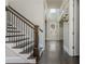Elegant staircase with dark wood treads and wrought iron railings, creating an inviting and stylish entrance at 4425 Atwood Dr, Cumming, GA 30040