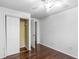 Bedroom with hardwood floors, ceiling fan, and double door closet at 8827 Applegate Ln, Atlanta, GA 30350