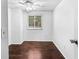 This bedroom includes dark wood flooring and a ceiling fan at 8827 Applegate Ln, Atlanta, GA 30350