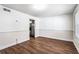 Dining area featuring wood floors, neutral walls, and a view into the updated kitchen at 8827 Applegate Ln, Atlanta, GA 30350