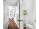 Hallway with beautiful flooring, fresh white paint, and a half bath at 8827 Applegate Ln, Atlanta, GA 30350
