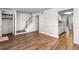Spacious living area with wood floors, closet and staircase, leading to the upper level, with views to the kitchen at 8827 Applegate Ln, Atlanta, GA 30350