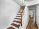 Staircase with wooden handrail, leading to the upper level, showcasing the home's bright and open design at 8827 Applegate Ln, Atlanta, GA 30350
