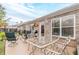 Inviting back patio area featuring an outdoor dining set, chairs, and a well-maintained brick exterior at 1152 Simonton Glen Way, Lawrenceville, GA 30045