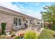 Charming backyard patio featuring outdoor seating, lush landscaping, and well-manicured lawn at 1152 Simonton Glen Way, Lawrenceville, GA 30045