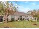 Backyard featuring a manicured lawn, patio seating, and a brick home exterior at 1152 Simonton Glen Way, Lawrenceville, GA 30045