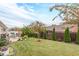 Landscaped backyard featuring a well-maintained lawn, patio seating area, and mature trees at 1152 Simonton Glen Way, Lawrenceville, GA 30045