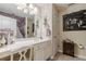 Cozy bathroom with a white vanity, large mirror, decorative accents, and tile flooring at 1152 Simonton Glen Way, Lawrenceville, GA 30045