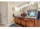 Classic bathroom featuring granite countertops, wood cabinetry, and a chandelier at 1152 Simonton Glen Way, Lawrenceville, GA 30045