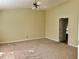 Empty bedroom featuring carpet, fresh paint, and a ceiling fan with lights at 1152 Simonton Glen Way, Lawrenceville, GA 30045