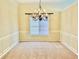 Formal dining area with wainscoting and an elegant chandelier for sophisticated meals at 1152 Simonton Glen Way, Lawrenceville, GA 30045