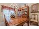 Elegant dining room with a large wooden table, chandelier, and decorative china cabinet at 1152 Simonton Glen Way, Lawrenceville, GA 30045