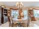 Cozy dining room featuring a chandelier, large windows, and classic furniture for memorable gatherings at 1152 Simonton Glen Way, Lawrenceville, GA 30045