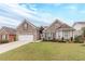 Inviting single-Gathering home showcasing a pristine lawn and a driveway leading to an attached two-car garage at 1152 Simonton Glen Way, Lawrenceville, GA 30045