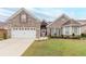 Charming brick home with a well-manicured lawn and a two-car garage, offering curb appeal at 1152 Simonton Glen Way, Lawrenceville, GA 30045