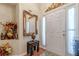 Elegant foyer with a decorative mirror and accent table, showcasing the home's style at 1152 Simonton Glen Way, Lawrenceville, GA 30045