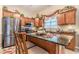 Well-lit kitchen boasting stainless steel appliances, dark countertops, and a center island at 1152 Simonton Glen Way, Lawrenceville, GA 30045