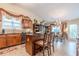 Open kitchen featuring wooden cabinetry, granite countertops, and an island with seating at 1152 Simonton Glen Way, Lawrenceville, GA 30045