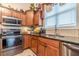 Modern kitchen featuring stainless steel appliances, granite countertops, and custom cabinetry at 1152 Simonton Glen Way, Lawrenceville, GA 30045