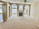 Open-concept living room with fireplace, arches, and abundant natural light to make a home airy and inviting at 1152 Simonton Glen Way, Lawrenceville, GA 30045