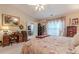 Inviting main bedroom with neutral tones and a decorative floral bedspread at 1152 Simonton Glen Way, Lawrenceville, GA 30045
