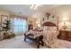 Comfortable main bedroom featuring a classic bed and decorative floral curtains at 1152 Simonton Glen Way, Lawrenceville, GA 30045