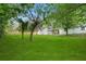 Well-maintained backyard featuring green lawn, mature trees, and a wood fence providing privacy at 1441 Ezra Church Nw Dr, Atlanta, GA 30314