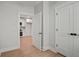 Bedroom with white doors and trim, wood-look flooring, and a partial view of the kitchen at 1441 Ezra Church Nw Dr, Atlanta, GA 30314