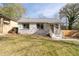 Quaint cottage-style house with stone facade and a cozy front porch entrance with light colored wood at 1441 Ezra Church Nw Dr, Atlanta, GA 30314