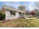 Charming stone home featuring mature trees and a well-maintained lawn on a sunny day at 1441 Ezra Church Nw Dr, Atlanta, GA 30314