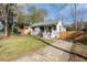 Charming stone home boasting a freshly mowed lawn and a newly installed light colored wooden fence at 1441 Ezra Church Nw Dr, Atlanta, GA 30314