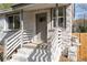 Close-up of the home's inviting front porch entrance with freshly painted steps and stone exterior at 1441 Ezra Church Nw Dr, Atlanta, GA 30314
