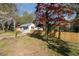 Spacious front yard with fresh wooden fence and a mature tree offering shade and curb appeal at 1441 Ezra Church Nw Dr, Atlanta, GA 30314