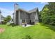 Large backyard with a patio, lawn, and treeline at 1803 Gold Finch Way, Lawrenceville, GA 30043