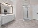 Bathroom featuring a white vanity, shower, and commode at 1803 Gold Finch Way, Lawrenceville, GA 30043