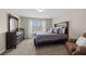 Cozy bedroom featuring a comfortable bed, dresser, carpeted flooring and a window for natural lighting at 1803 Gold Finch Way, Lawrenceville, GA 30043