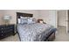Bedroom features a decorative bed, lamp, neutral walls, carpeted flooring, and a view to the hallway at 1803 Gold Finch Way, Lawrenceville, GA 30043