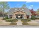 Community clubhouse featuring stone accents, manicured landscaping, and inviting entrance at 1803 Gold Finch Way, Lawrenceville, GA 30043