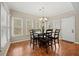 Cozy dining area featuring a chandelier, multiple windows with natural light, and a tile floor at 1803 Gold Finch Way, Lawrenceville, GA 30043