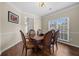 Cozy dining room featuring hardwood floors, natural light, and neutral wall colors at 1803 Gold Finch Way, Lawrenceville, GA 30043