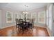Dining room with views of the outside, a chandelier, and seating for six at 1803 Gold Finch Way, Lawrenceville, GA 30043
