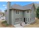 Rear exterior view of home showing green siding, patio, and multiple windows at 1803 Gold Finch Way, Lawrenceville, GA 30043