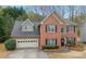 Charming two-story brick home with manicured lawn and black shutters at 1803 Gold Finch Way, Lawrenceville, GA 30043