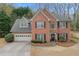 Charming two-story brick home with a manicured lawn and attached two-car garage at 1803 Gold Finch Way, Lawrenceville, GA 30043