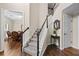 Inviting foyer featuring a staircase, hardwood floors, and a glimpse into the dining room at 1803 Gold Finch Way, Lawrenceville, GA 30043