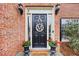 Close up of the front door, framed by sidelights and featuring decorative touches at 1803 Gold Finch Way, Lawrenceville, GA 30043