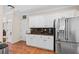 Kitchen featuring granite countertops, white cabinetry, stainless steel appliances, and eat-in dining space at 1803 Gold Finch Way, Lawrenceville, GA 30043